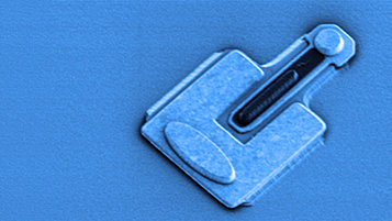 Grayscale SEM image of an Indium phosphide heterojunction bipolar transistor, colored in light blue. 