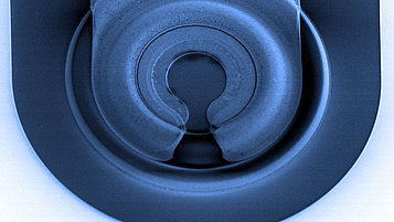 SEM image of a VCSEL (Vertical-Cavity Surface-Emitting Laser) structure, showing intricate circular layers and a precise, symmetric design for efficient optical performance.